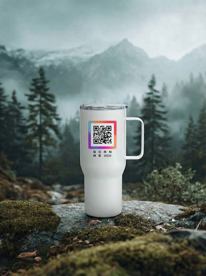 White travel mug with colorful QR code, outdoors among moss, rocks, and pine trees
